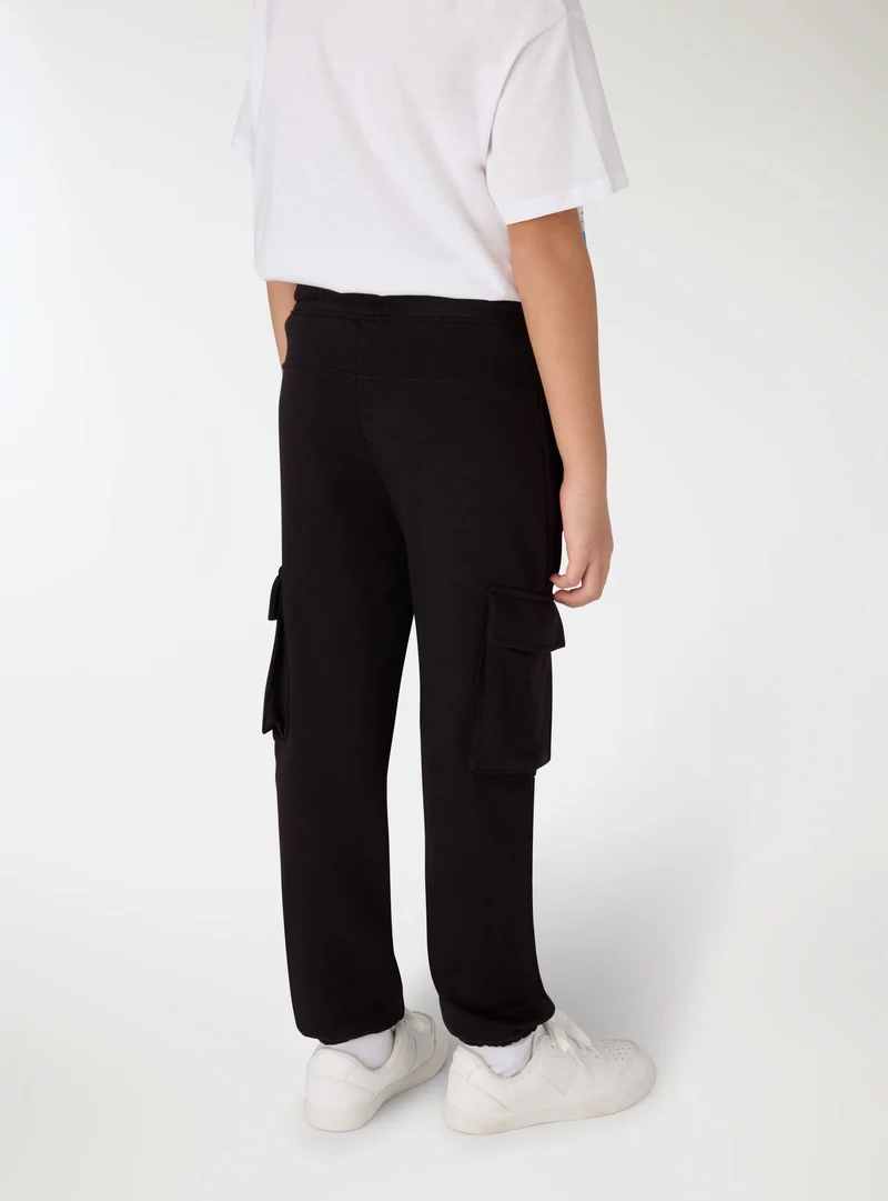 Pantaloni tuta cargo tinta unita